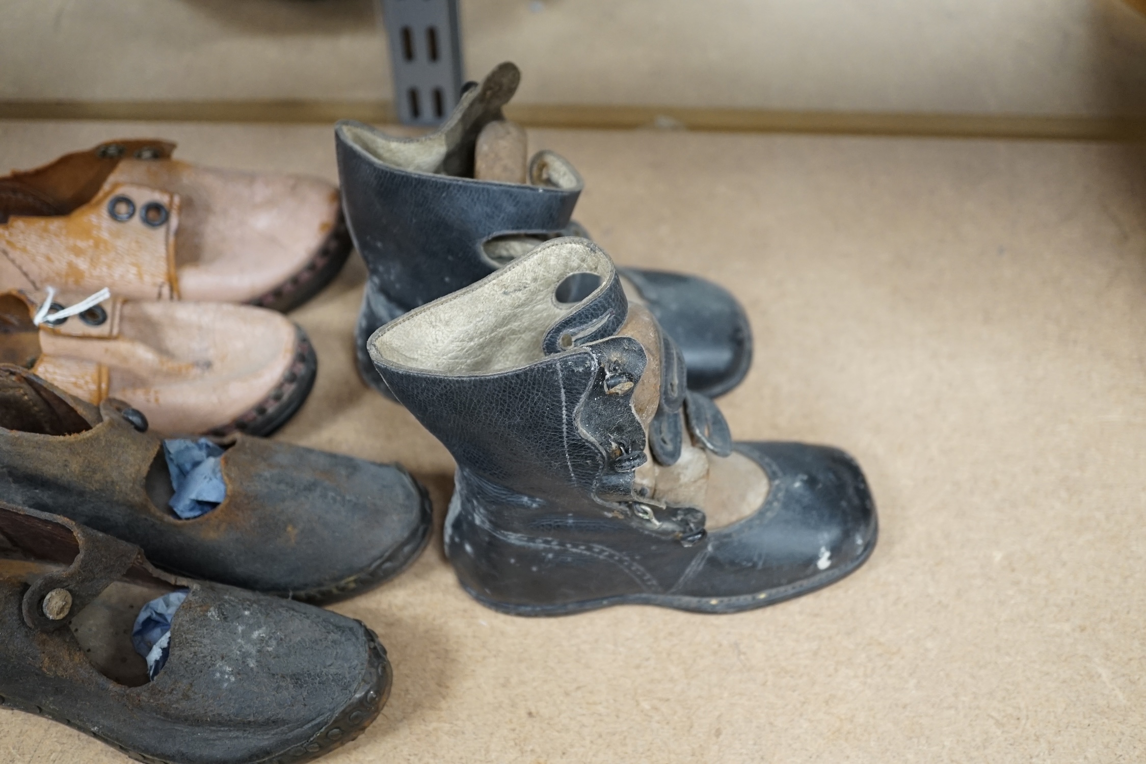 Three pairs of late 19th / early 20th century children’s boots and clogs, largest 14cm in length. Condition - poor to fair